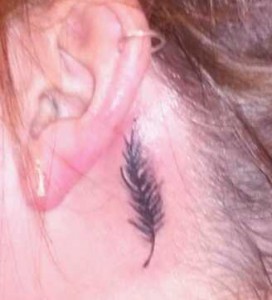 Black feather behind ear