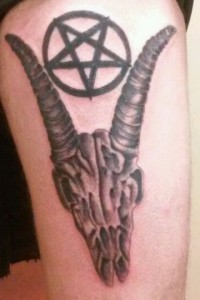 Greyscale skull and pentagram tattoo