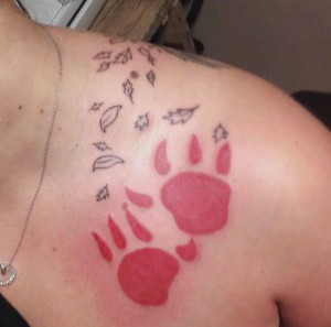 Paw prints and leaves over shoulder
