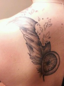 Greyscale feather on back of shoulder