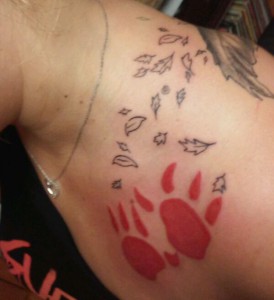 Paw prints and leaves over shoulder
