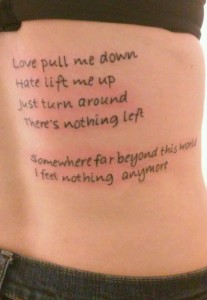 Quote tattoo on back of ribcage